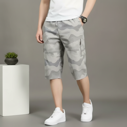 Close-up portrait of Alex Smith, a person looking confidently at the camera, wearing CARGONIX shorts with a washed camouflage